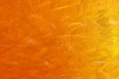 画布上橙色颜料的抽象背景.橘色颜料的乱画.