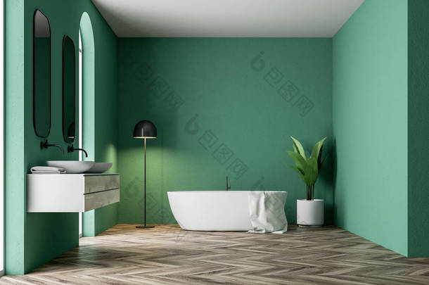 简约<strong>绿色</strong>浴室内有一个白色的浴缸, 一条毛巾挂在它, 一个双水槽, 一棵盆栽树和一盏灯在角落里。3d 渲染模拟