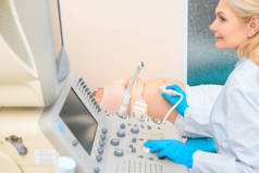 产科妇科医生对孕妇进行超声扫描的侧面检视