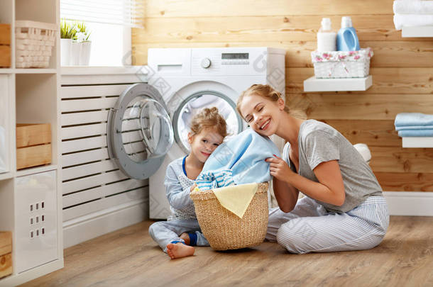 快乐家庭母亲的家庭主妇和孩子在洗衣店与塑封