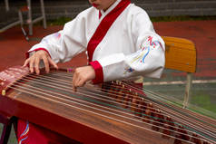 一个小女孩在弹奏古正乐器