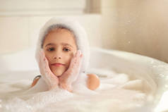 这个女孩在浴室里洗澡和玩耍泡沫。这是一个很大的下降。吹泡泡