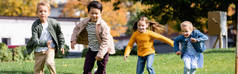 快乐的多文化儿童在公园里奔跑，横幅 