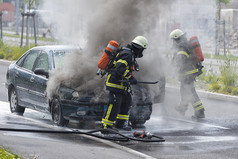 消防队员正在扑灭燃烧的汽车