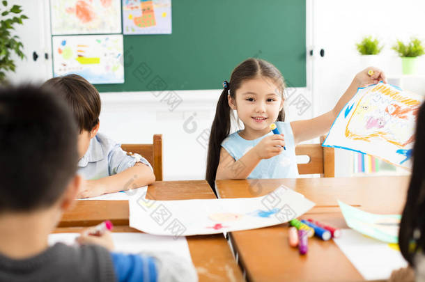快乐的小女孩在教室里画画