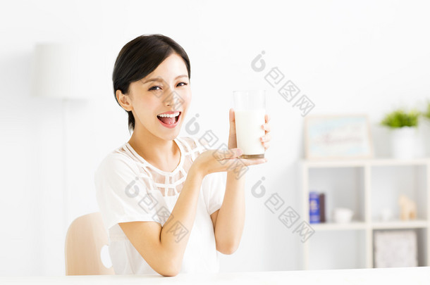 快乐的年轻女人喝<strong>牛奶</strong>
