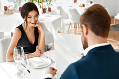 Romantic Couple In Love. Dinner In Restaurant. Romance And Relat