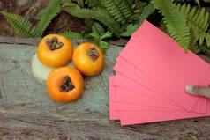 柿子果实与红色的信封，中国新的一年
