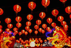 Red lanterns hanging in the black sky and god lamp at night in the Lantern Festival in Thailand.