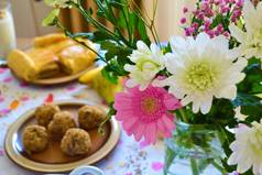用香甜可口的食物和一个盛有花的花瓶装饰一个早午餐桌