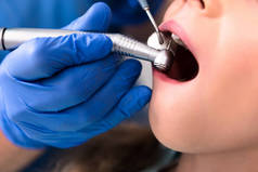 裁剪拍摄的牙医与牙科手处理与小孩的牙齿