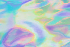 全息箔纹理。抽象柔和的虹彩背景。五颜六色的阳光斑