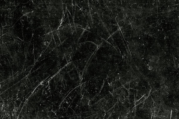 黑色背景上的白色划痕和灰尘。古色古香的磨碎了的塑料碎屏幕纹理.碎玻璃表面壁纸.肮脏的黑板。案文的篇幅.