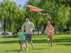 公园里有三只放风筝的快乐家庭