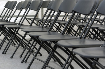 众多折叠椅子安排行会议房间