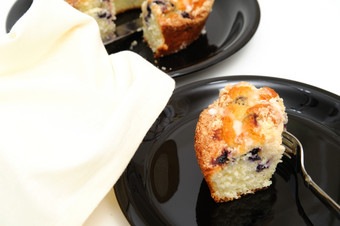 蓝莓环蛋糕片新鲜的烤蓝莓环蛋糕服务黑色的板与光彩色的背景