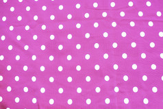 粉红色的和白色波尔卡点印刷织物有趣的浪漫的背景纹理粉红色的和白色波尔卡点印刷织物