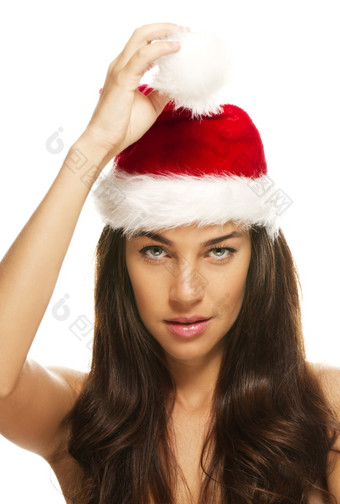 年轻的美丽的女人持有提示圣诞老人帽子年轻的美丽的圣诞节女人持有提示圣诞老人帽子白色背景