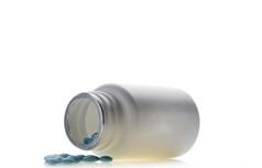 蓝色的药片药丸瓶孤立的背景蓝色的药片药丸瓶孤立的白色背景