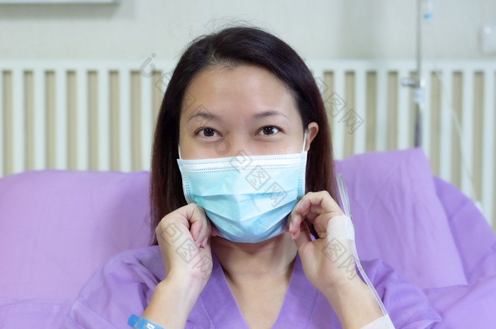年轻的亚洲女病人微笑和显示医疗面具病人感觉快乐和舒适的与治疗和治疗医院床上医院房间医疗医疗保健概念医疗医疗保健概念