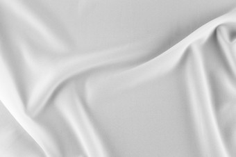光滑的优雅的白色丝绸缎奢侈品布可以使用婚礼<strong>背景</strong>豪华的圣诞节<strong>背景</strong>新一<strong>年背景</strong>设计白色织物纹理布纺织表面前视图光滑的白色丝绸缎纹理