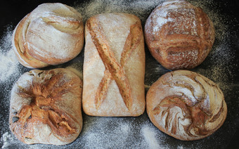 分类新鲜的面包黑色的背景概念烹饪成功的商人开始分类新鲜的面包黑色的背景概念烹饪成功的商人开始
