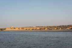 埃及海滩与典型的阳伞的背景和红色的海frontground