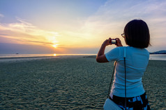亚洲女人旅游采取照片的海滩和美丽的自然景观色彩斑斓的天空和海在日落纳通日落的观点寒岛这封信他尼府泰国女人旅游采取照片的海滩