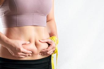 脂肪女人脂肪肚子胖乎乎的肥胖女人手持有过度肚子脂肪与测量磁带女人饮食生活方式概念