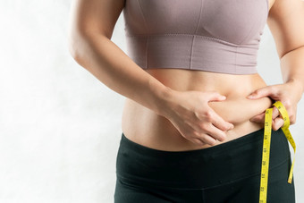 脂肪女人脂肪肚子胖乎乎的肥胖女人手持有<strong>过度</strong>肚子脂肪与测量磁带女人饮食生活方式概念