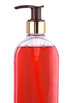 的关闭透明的瓶与液体肥皂白色背景关闭透明的瓶与液体肥皂白色背景