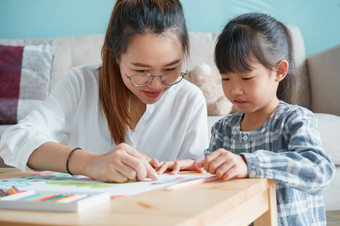 亚洲家庭与妈妈。和女儿做在一起<strong>活动首页</strong>快乐妈妈和孩子做学习和画表格的生活房间的早....