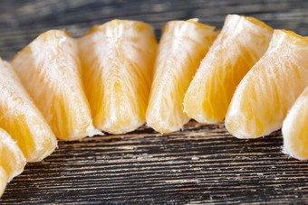 普通话片把行从成熟的橙色柑橘类水果切片成片木表面普通话片
