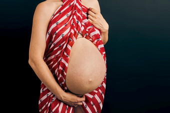 怀孕了女人触碰她的肚子站在平原背景怀<strong>孕期</strong>望母亲概念