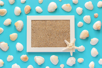 白色框架与海沙子和海星贝壳蓝色的背景有创意的平躺前视图模板模型为明信片设计文本白色框架与海沙子和海星贝壳蓝色的背景有创意的平躺前视图模板模型为明信片设计文本