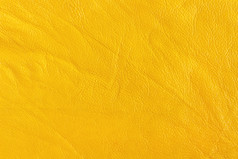 表面皮革替代与折痕和皱纹黄色的颜色组织抽样背景纹理
