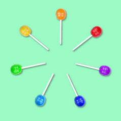 集色彩斑斓的棒棒糖分组圆孤立的绿色背景糖果坚持食物背景平躺集色彩斑斓的棒棒糖分组圆孤立的绿色背景