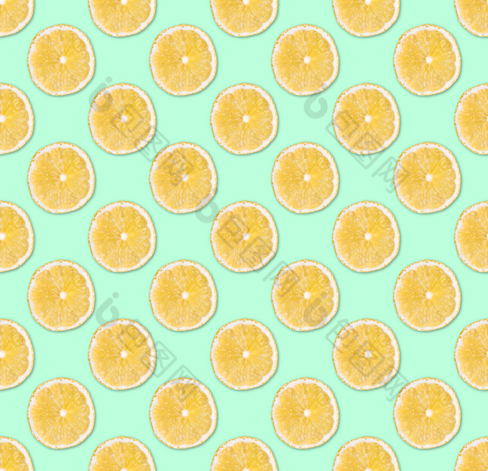 新鲜的黄色的柠檬片无缝的模式关闭柑橘类水果片柔和的蓝色的背景工作室摄影背景新鲜的黄色的柠檬片无缝的模式关闭工作室摄影