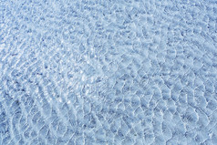 蓝色的水游泳池赢富数据纹理水与小波和太阳耀斑背景夏天假期概念