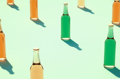 特写镜头各种各样的颜色玻璃瓶行对光蓝色的绿色表面原型完整的和关闭玻璃瓶没有标签阴影背景复古的喝瓶概念