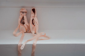 尖端鞋子为芭蕾舞女演员木背景芭蕾舞鞋子粉红色的美丽的尖端鞋子为芭蕾舞女演员木背景芭蕾舞鞋子粉红色的