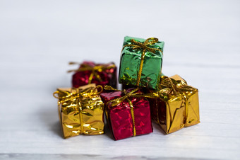 桩彩色的闪亮的礼物盒子与复制空间白色木背景现代复古的圣诞节设计色彩斑斓的礼物假期概念空间为文本桩彩色的闪亮的礼物盒子与复制空间白色木背景现代复古的圣诞节设计色彩斑斓的礼物假期概念