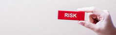 商人手持有风险词红色的木块与复制空间业务规划管理解决方案保险质量控制和策略概念