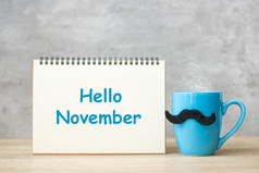 你好11月与纸记事本蓝色的咖啡杯茶杯子和黑色的胡子装饰表格国际但一天快乐父亲一天和庆祝活动概念