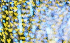 快乐x-mas黄色的色彩斑斓的光摘要心散景的光隧道圣诞节树背景装饰在圣诞节和爱新一年节日照明