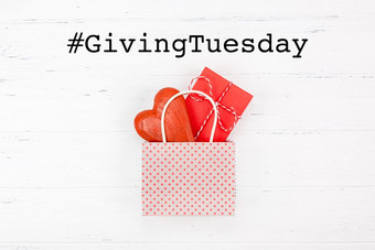 给周二全球一天慈善给后黑色的星期五购物一天慈善机构给帮助捐款和支持概念与文本消息红色的心和礼物购物袋