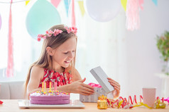 可爱的小女孩快乐和兴奋她的生日高加索人女孩生日节日色彩斑斓的背景与气球生日聚会，派对和祝愿概念