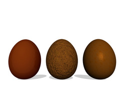 三个复活节鸡蛋使巧克力与他们的影子白色背景巧克力复活节鸡蛋