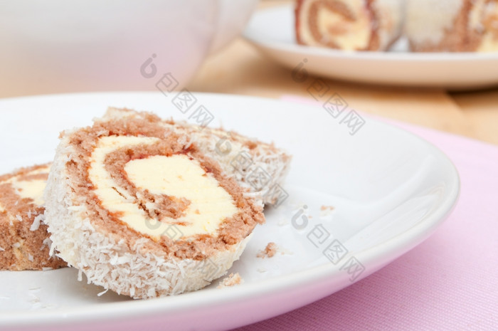 瑞士海绵卷甜点与奶油白色板浅深度场