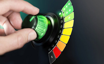 手把旋钮与效率规模从黑色的和红色的绿色颜色复合图像之间的手摄影和背景能源非常高效。概念
